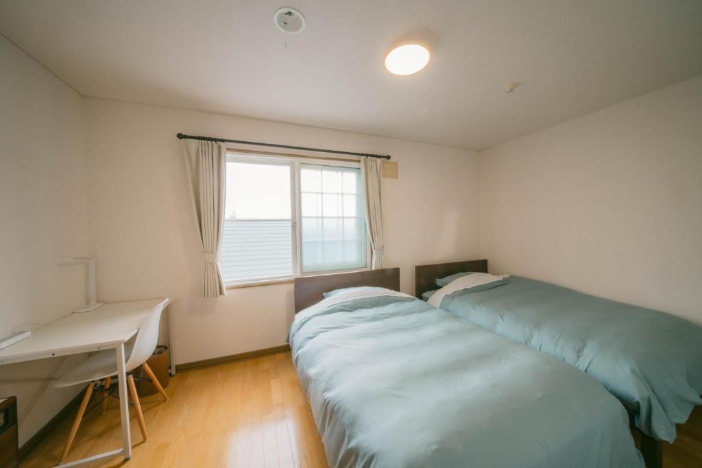 Postel nebo postele na pokoji v ubytování TESHIKAGA HOSTEL MISATO