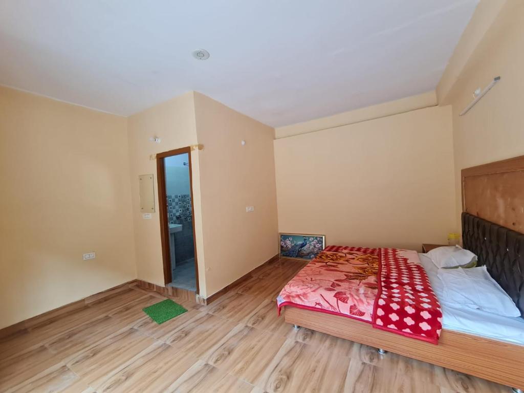 1 dormitorio con 1 cama con manta roja en Rivulet Resort & Camping en Mussoorie