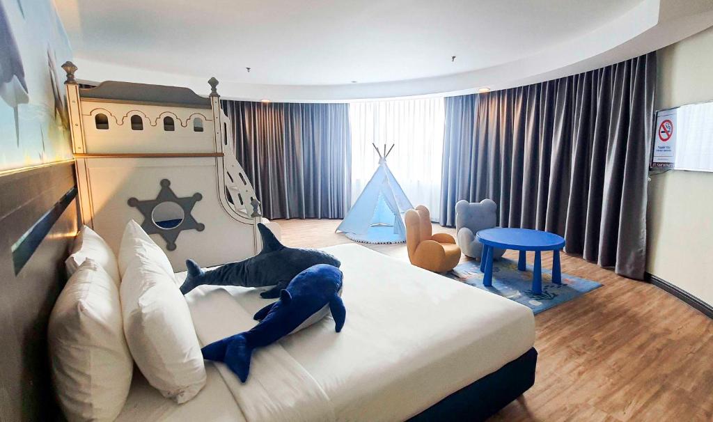 a bedroom with a bed with a dog on it at Premiere Hotel in Klang