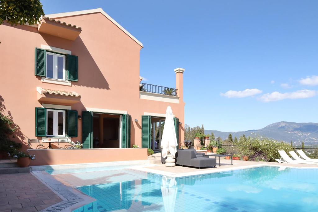 a villa with a swimming pool and a house at Casa T with amazing views in Corfu in Kontokali