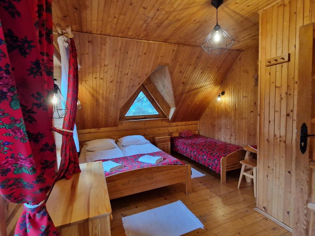 sypialnia z łóżkiem i oknem w kabinie w obiekcie Domek Góralski nad Czorsztynem - Kluszkowce w Kluszkowcach