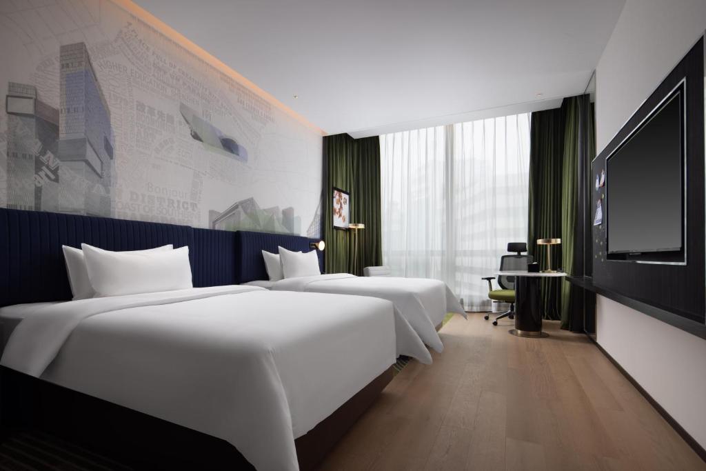 Postel nebo postele na pokoji v ubytování Hampton by Hilton Shenzhen Nanshan Science and Technology Park