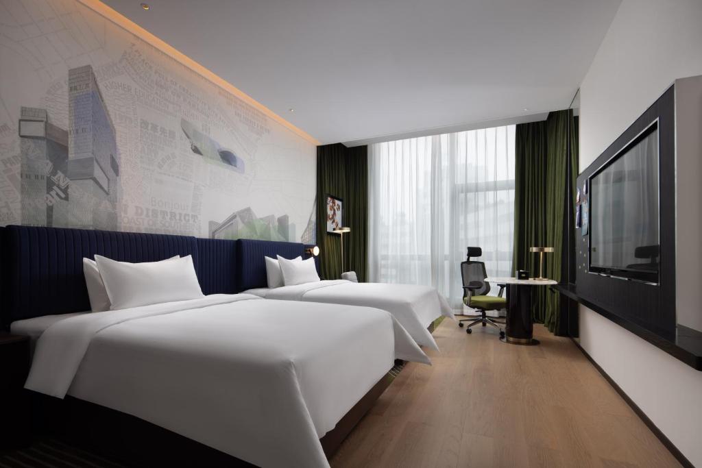 Postel nebo postele na pokoji v ubytování Hampton by Hilton Shenzhen Nanshan Science and Technology Park