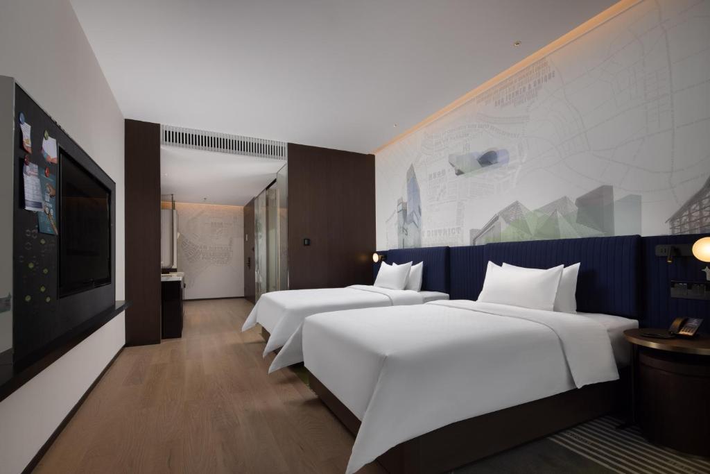 Postel nebo postele na pokoji v ubytování Hampton by Hilton Shenzhen Nanshan Science and Technology Park