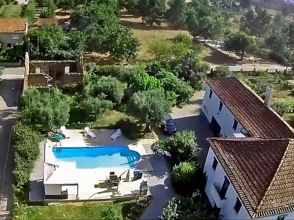 an aerial view of a house with a swimming pool at Private 2-bedroom apartment & private solar heated pool WiFi, AC in Tábua