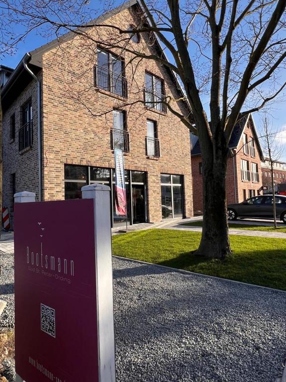 a brick building with a sign in front of it at Bootsmann Escapes in Böhl