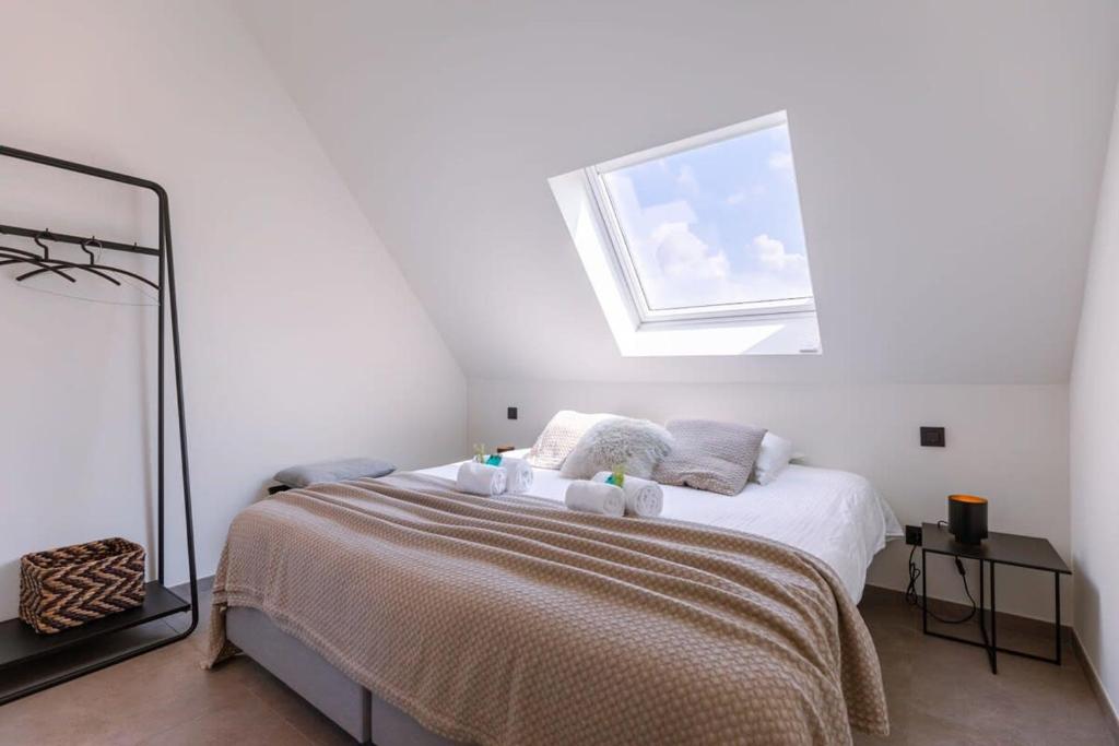 a bedroom with a bed with a window above it at Tosca - Charming double room at ranch "De Blauwe Zaal" in Bruges