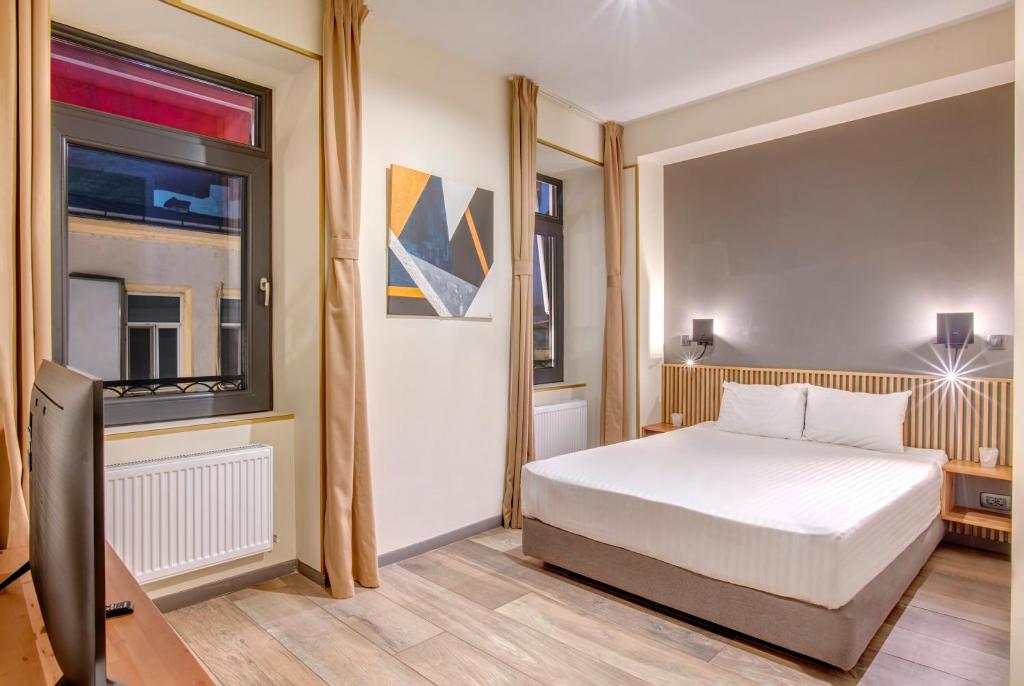 a bedroom with a bed and a window at Hotel Forty One in Bucharest