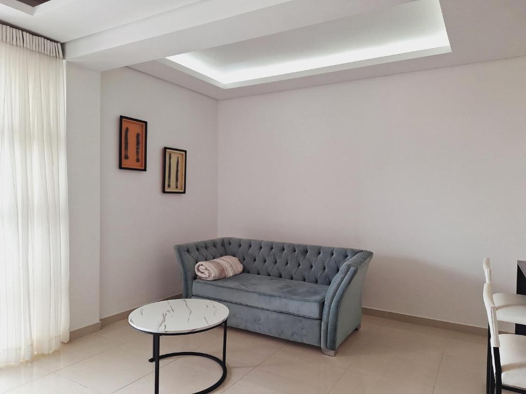 a living room with a couch and a table at Sophisticated apartment in Maputo