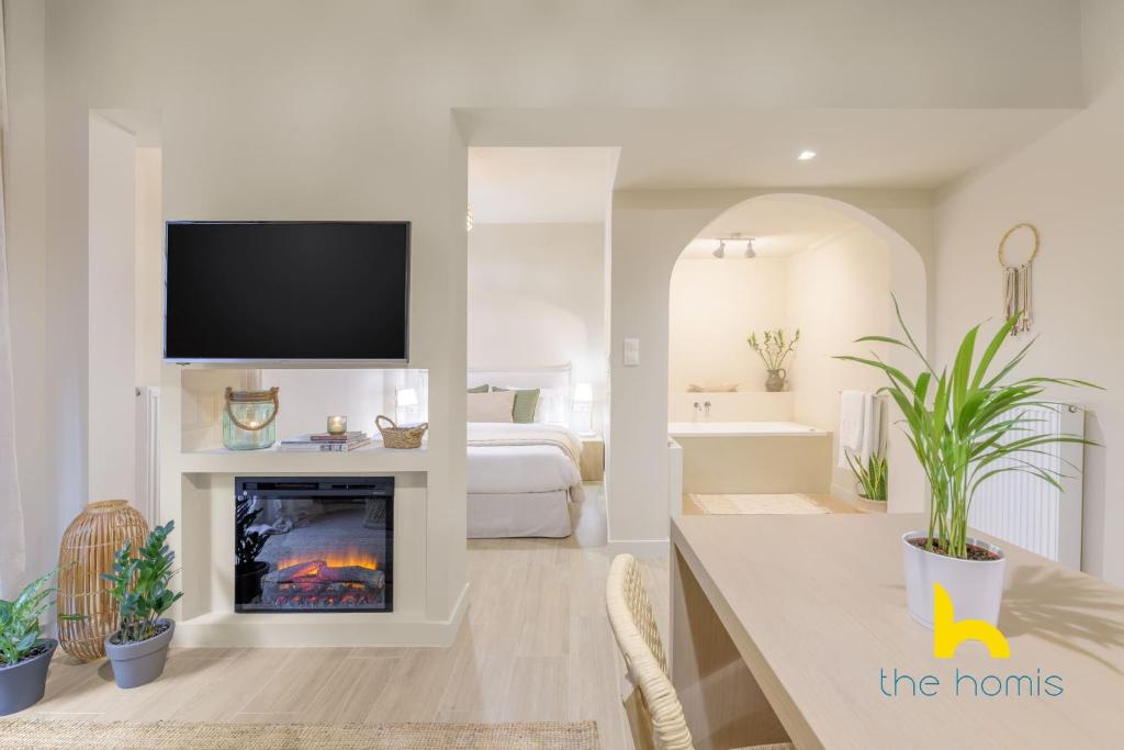 A television and/or entertainment centre at Romantic Luxury Hideaway Near Acropolis with Jacuzzi