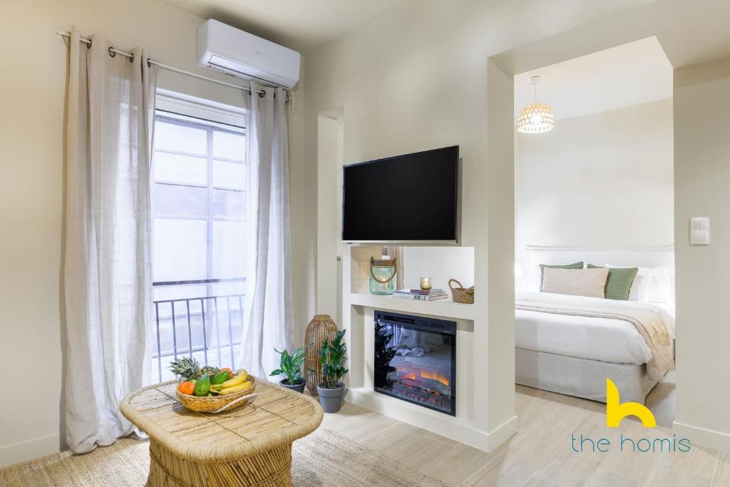 A television and/or entertainment centre at Romantic Luxury Hideaway Near Acropolis with Jacuzzi