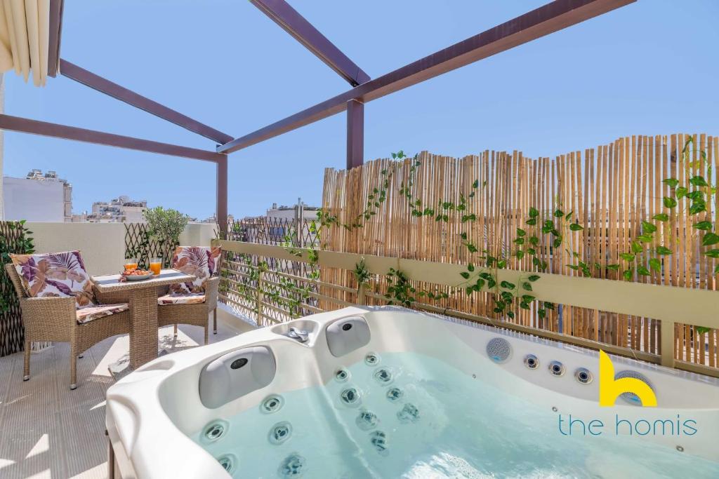 a jacuzzi tub on the balcony of a house at Athenian Sky Retreat: Jacuzzi & Fresh Elegance! in Athens