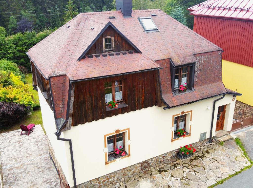 an aerial view of a house with flowers in the windows at Apartmány Chalupinka in Železná Ruda