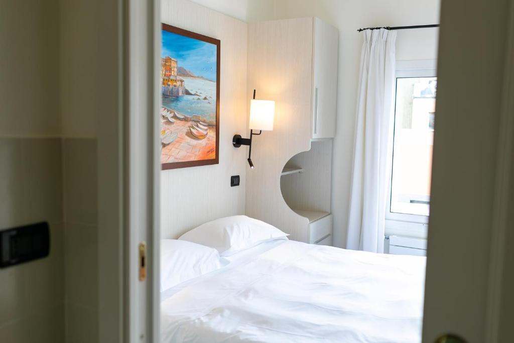 Un ou plusieurs lits dans un hébergement de l'établissement Rex Hotel Residence