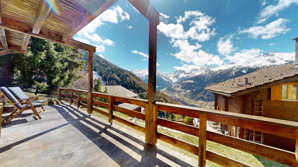 a balcony of a cabin with a view of mountains at Charming alpine studio in the Val d'Anniviers in Saint-Luc