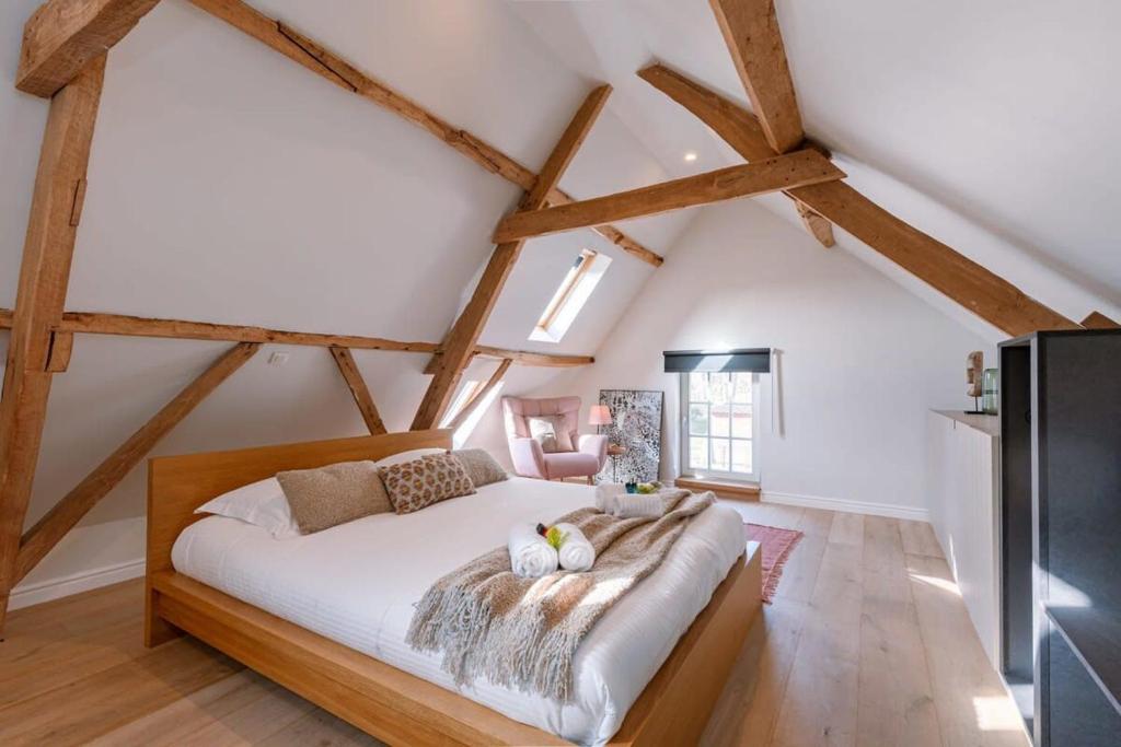 a bedroom with a large bed in the attic at Charming room in the green neighbourhood of Gent in Ghent