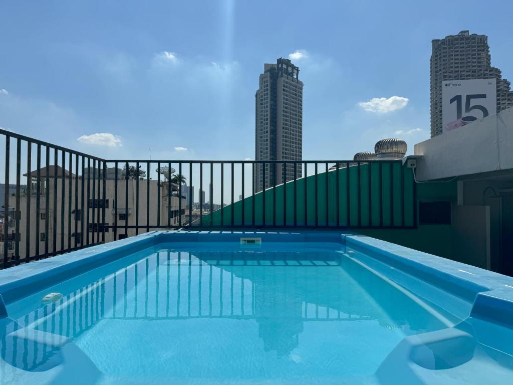 a swimming pool on the roof of a building at Pas Cher Hotel de Bangkok in Bangkok