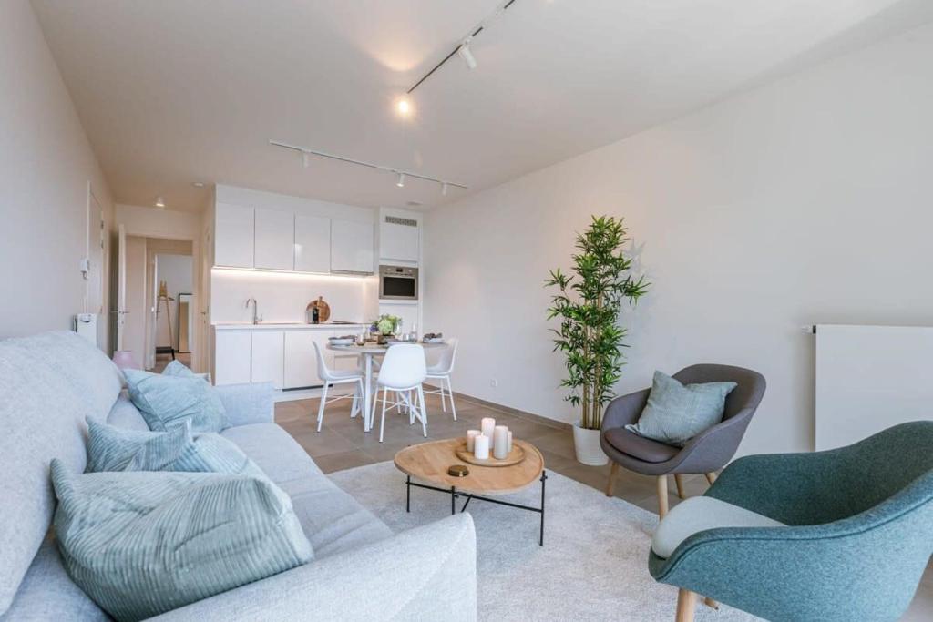 a living room with a couch and chairs and a table at Pleasant apartment at the lighthouse in Ostend in Ostend