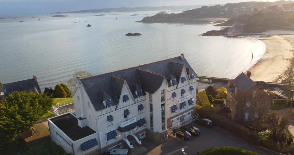 an aerial view of a building next to a body of water at Logis Hôtel de Carantec in Carantec