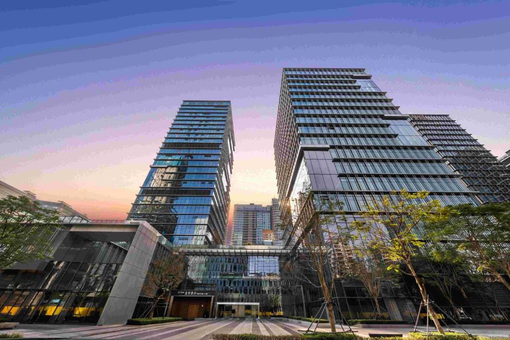 three tall skyscrapers in a city at Shenzhen Shekou Prince Bay Yifei Hotel in Shenzhen