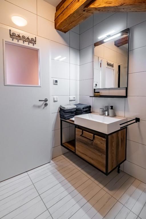 a bathroom with a sink and a mirror at Kníže Ferdinand Apartments in Mikulov