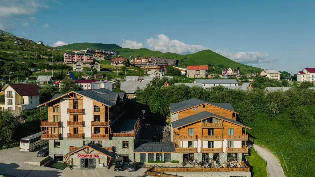 an aerial view of a town with houses and mountains at Gudauri Inn in Gudauri