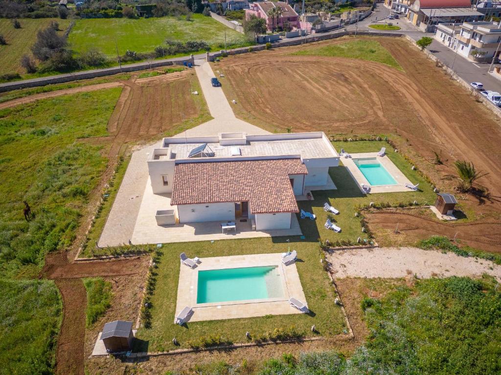 eine Luftansicht eines Hauses mit zwei Swimmingpools in der Unterkunft Villa Daisy in Caprarica di Lecce