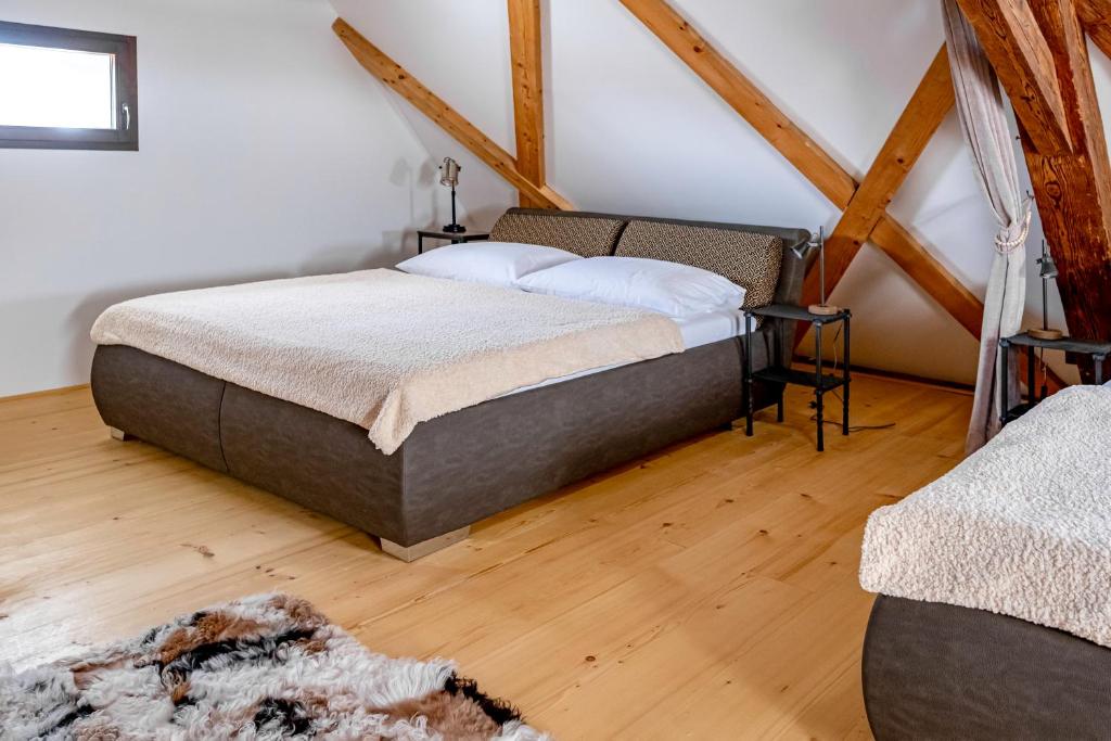 a bedroom with a bed in a room with wooden floors at Kníže Ferdinand Apartments in Mikulov