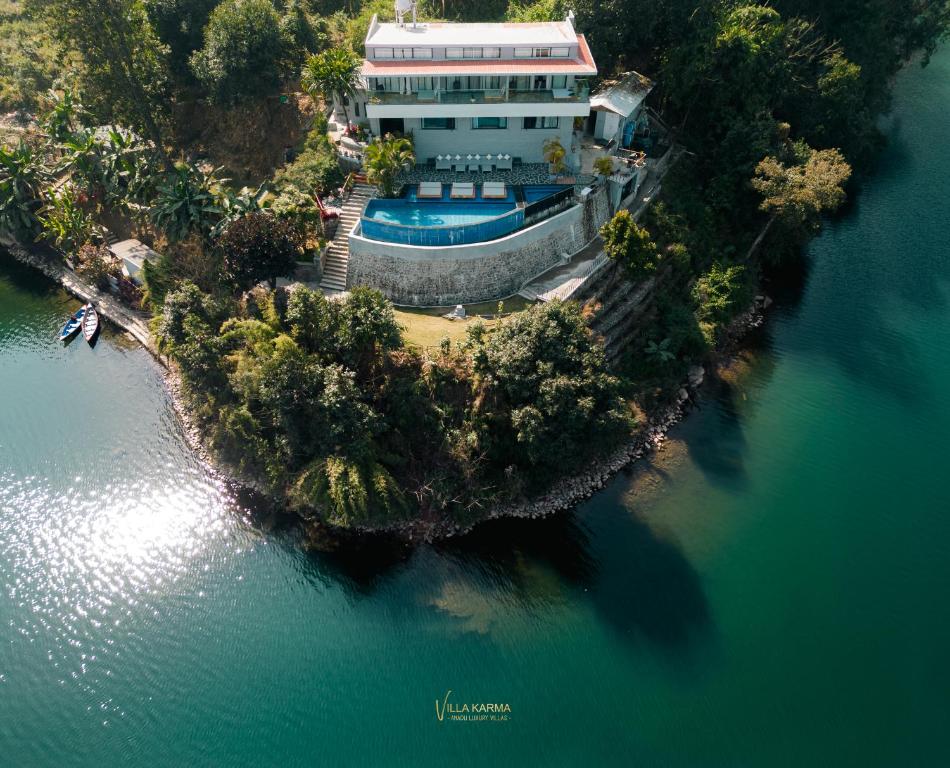 an aerial view of a house on an island in the water at Villa Karma Pokhara in Pokhara
