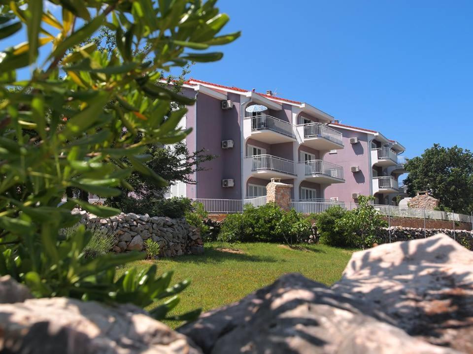 an apartment building with a lawn in front of it at Apartmani Marija Klimno A in Klimno