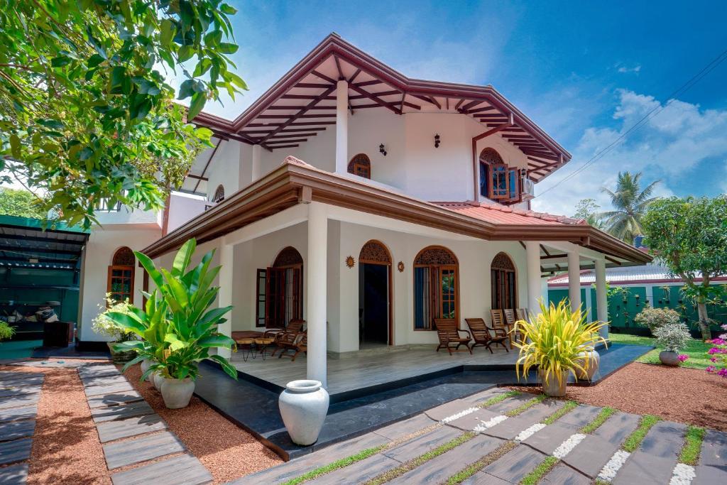 a white house with a red roof at Villa Sunbreeze in Beruwala