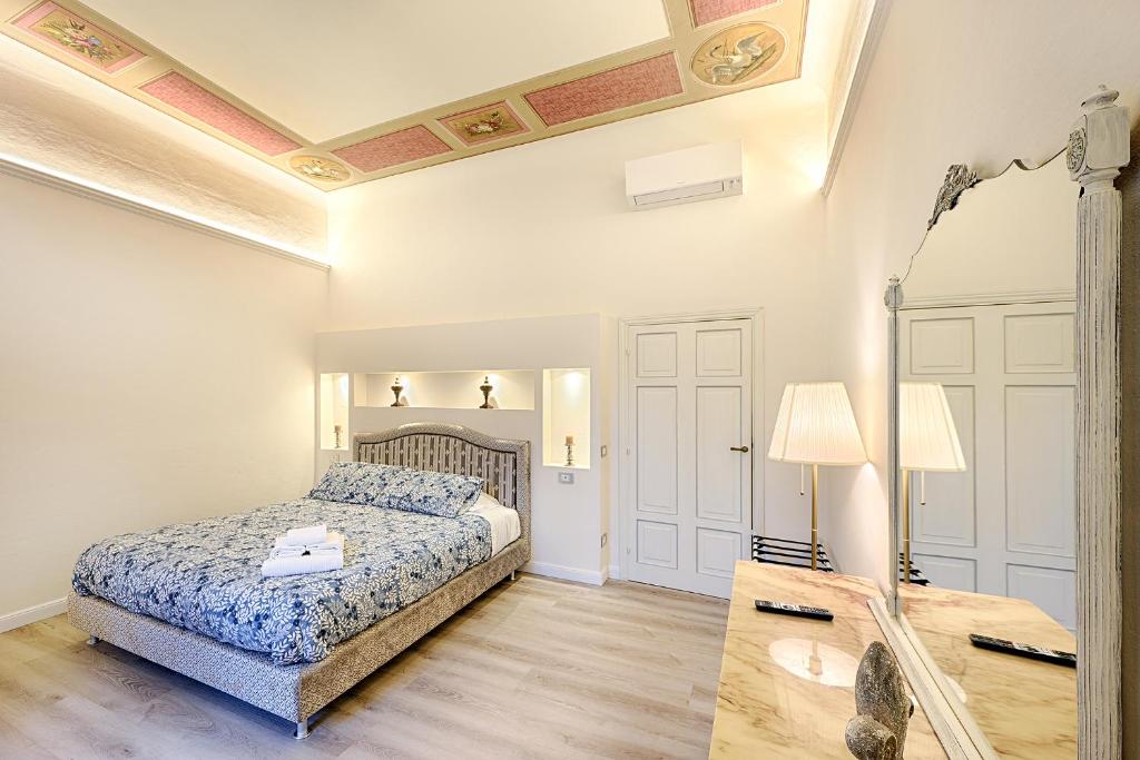a bedroom with a bed and a mirror and a table at Casa Ciseri in Siena