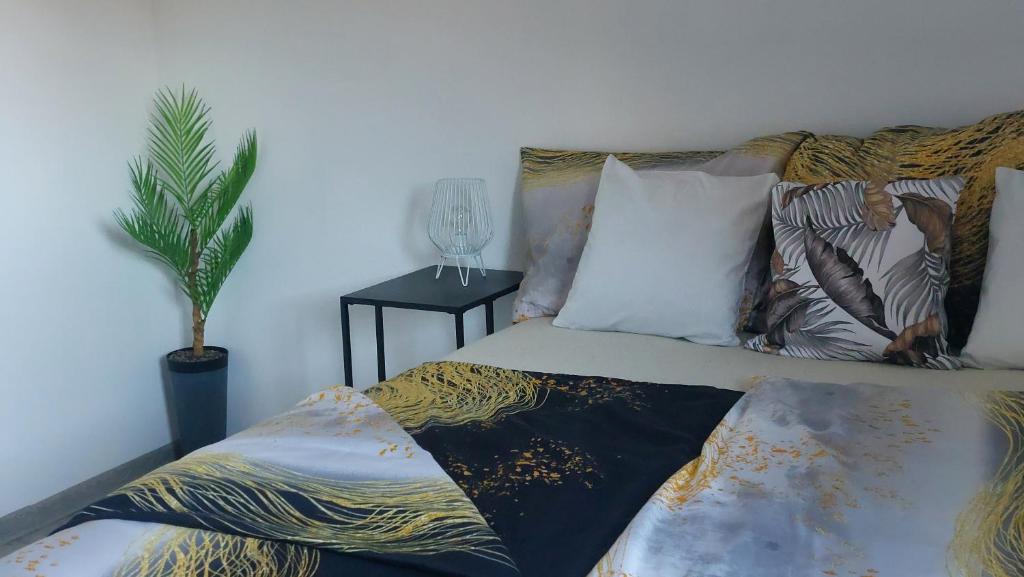 a bedroom with a bed with a plant on it at Spokojny zakątek in Ustroń