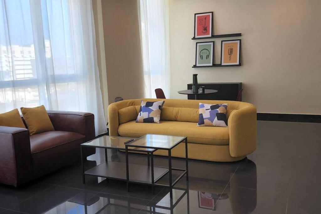 a living room with a couch and a coffee table at Smart Stay Salmiya apartment in Kuwait