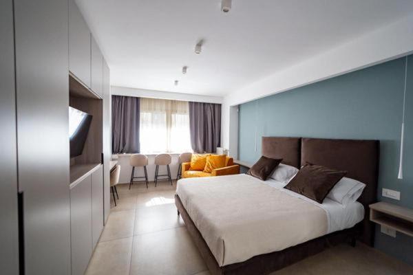 a bedroom with a bed and a living room at APARTMENT ANDROMEDA in Bari