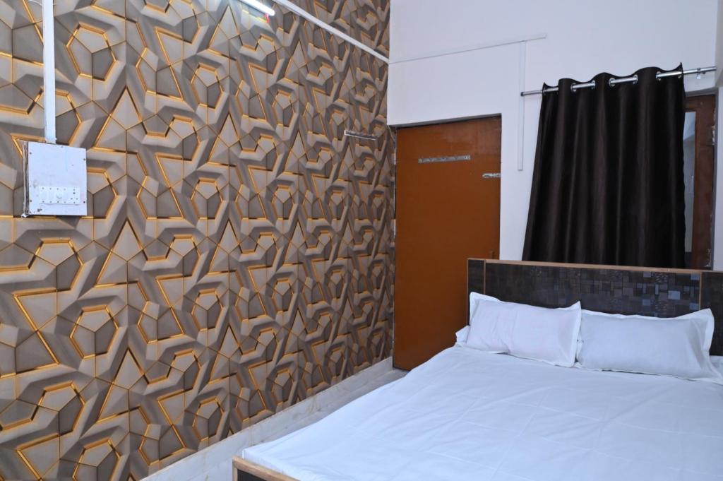 a bedroom with a bed and a wooden wall at Gorakhnath Guest House in Gorakhpur