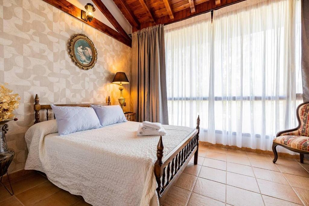 a bedroom with a bed and a large window at Villa Micaela in Lamadrid