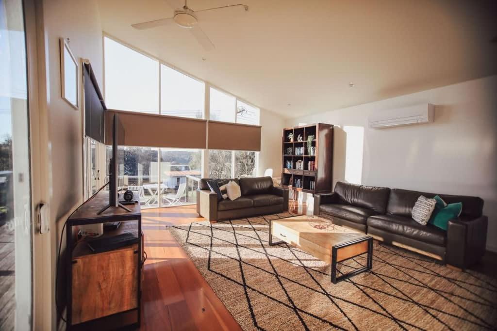 a living room with a couch and a table at Pitcher Vista in Port Campbell