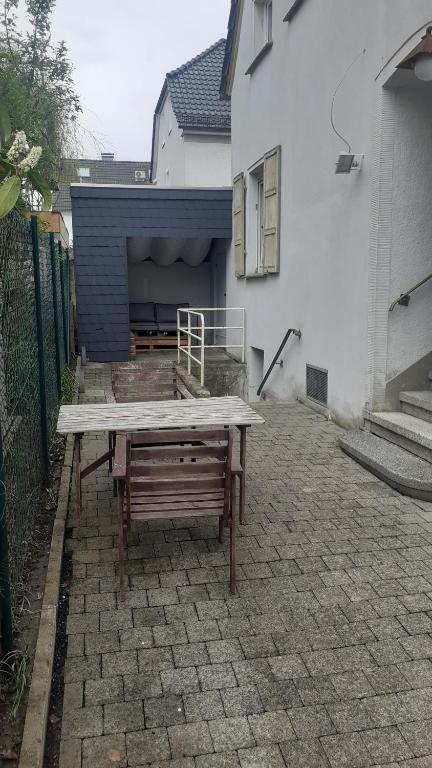 a wooden picnic table in front of a house at City Ferienhaus in Neheim in Arnsberg