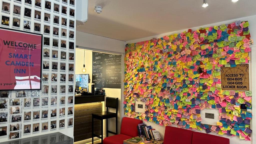 uma parede coberta de muitas notas pegajosas em Smart Camden Inn Hostel em Londres