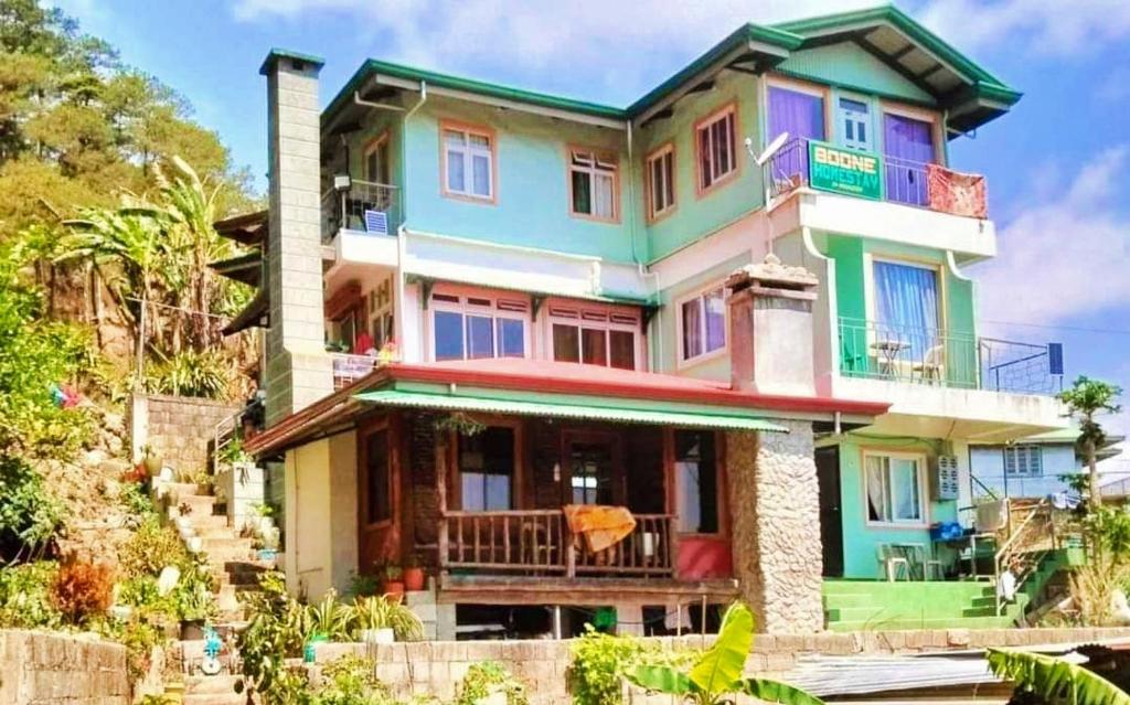 a colorful house with a balcony at Couple's Unit at BOONE'S in Sagada