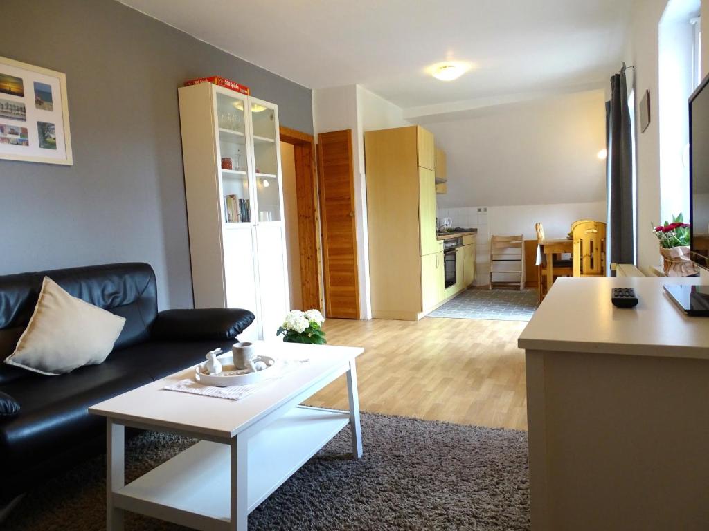 a living room with a couch and a table at Seestern in Grömitz