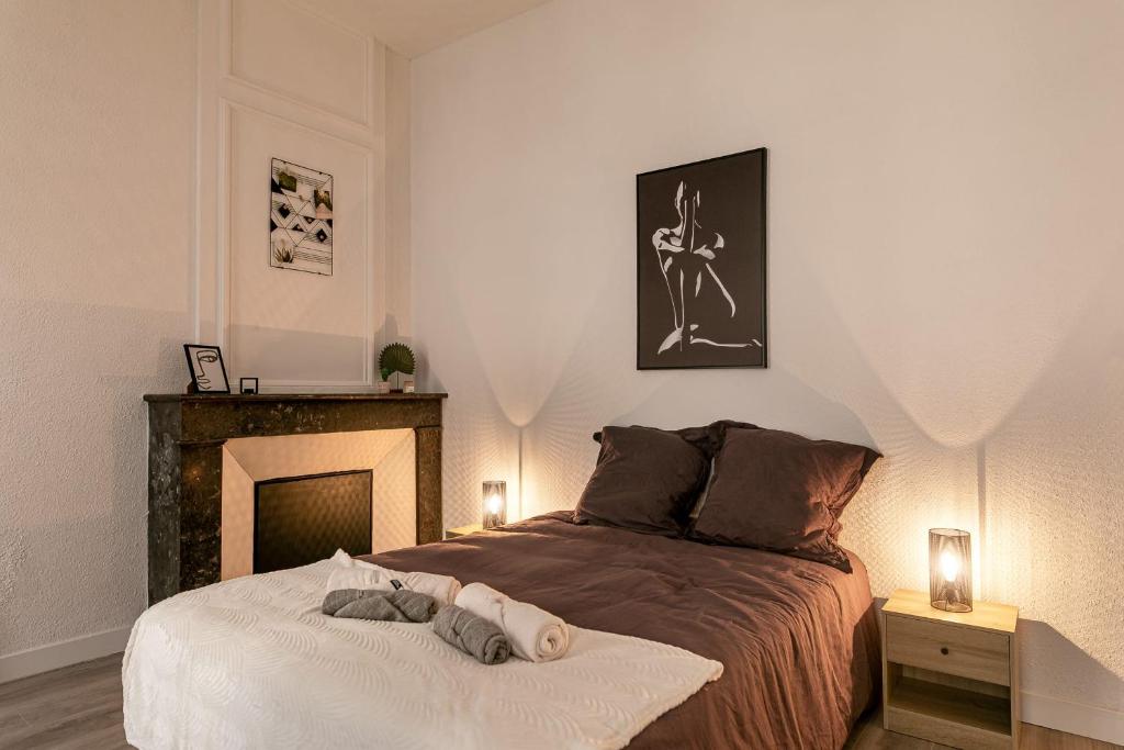 a bedroom with a bed with a fireplace in it at Lumineux T5 - Climatisation in Perpignan
