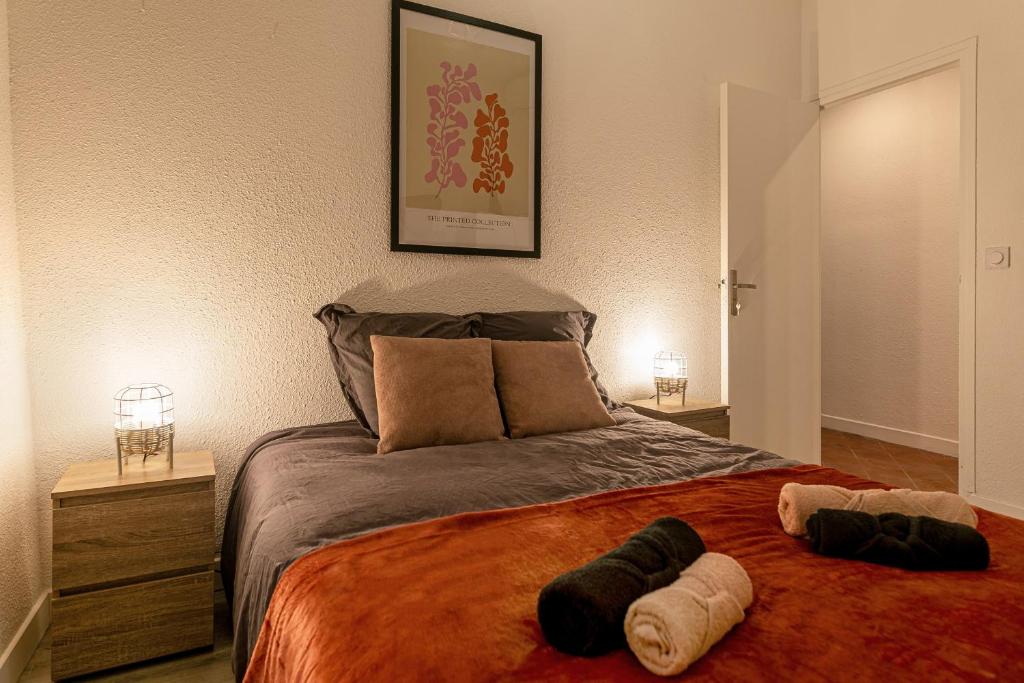 a bedroom with a large bed with two pillows on it at Lumineux T5 - Climatisation in Perpignan