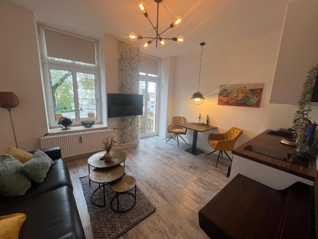 - un salon avec un canapé et une table dans l'établissement Modernes Wohnstudio mit Balkon im Herzen von Bad Rothenfelde, à Bad Rothenfelde