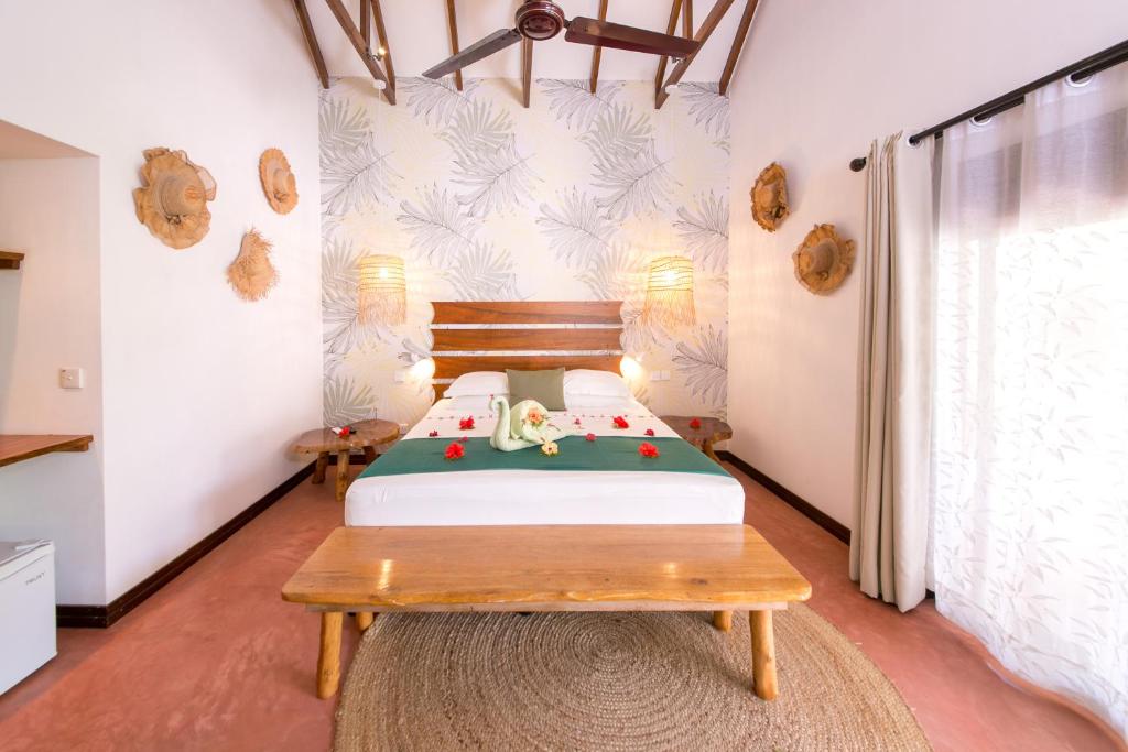 Postel nebo postele na pokoji v ubytování Les Lauriers Eco Hotel