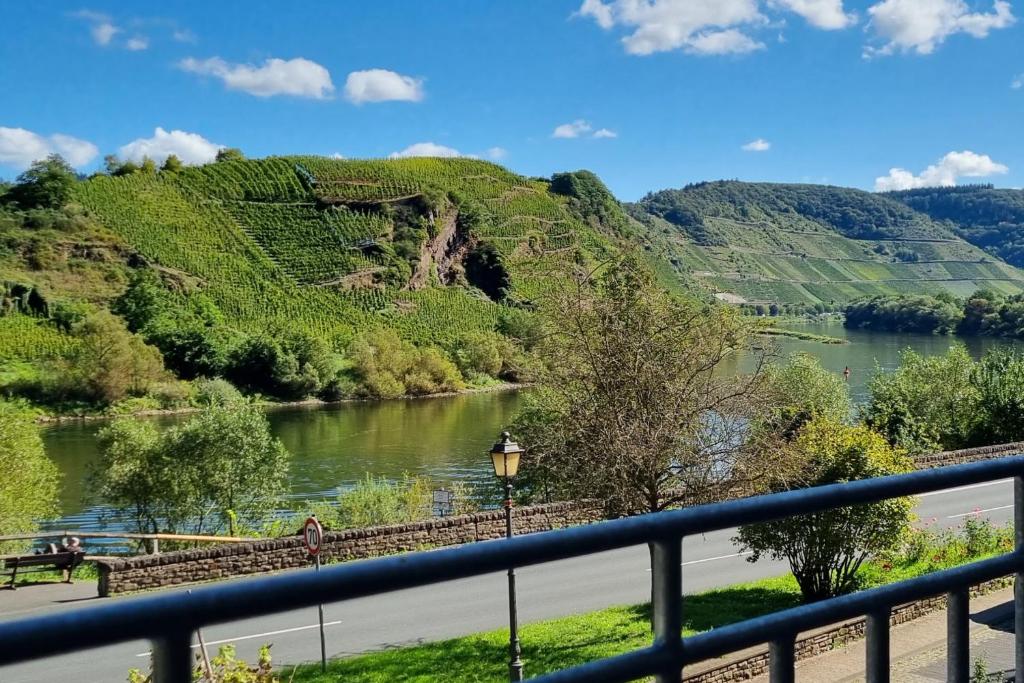 a view of a river and mountains with a bridge at Historisches Mosel-Refugium in Bremm