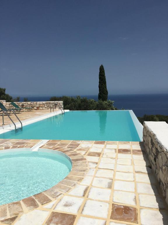einen Pool mit blauem Wasser und Meerblick in der Unterkunft Villa Xyloporta in Skinária