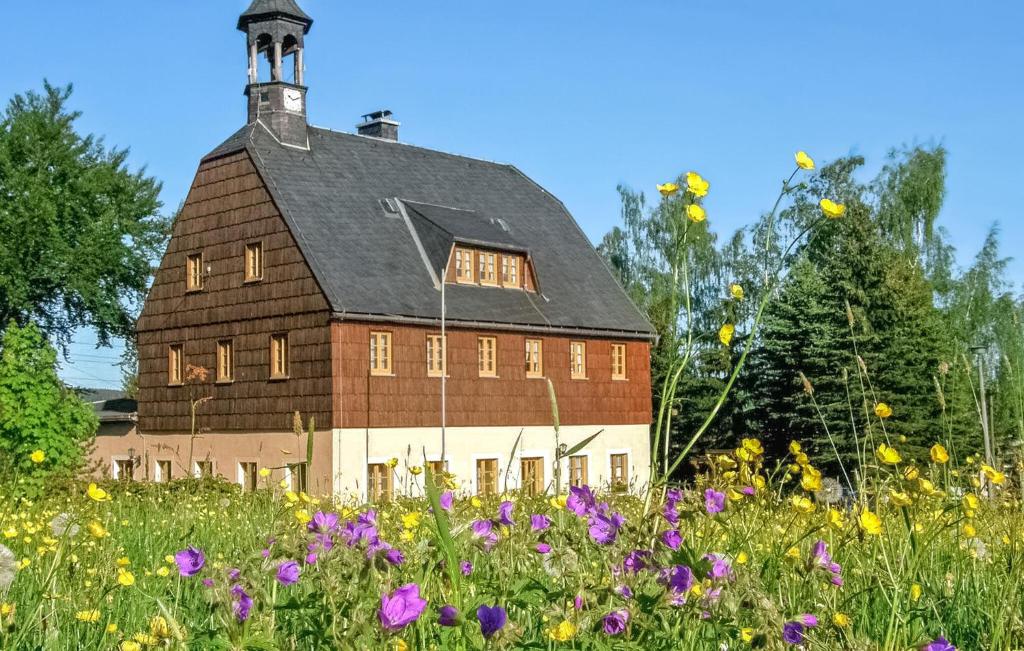 an old barn in a field of flowers at Beautiful Apartment In Neuhausen With Kitchen in Neuhausen