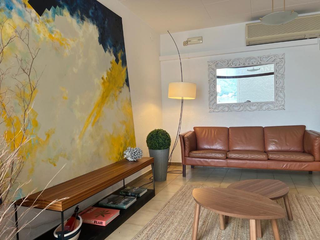 德拉塞爾瓦港的住宿－Hostal Sol i Sombra，带沙发和绘画的客厅